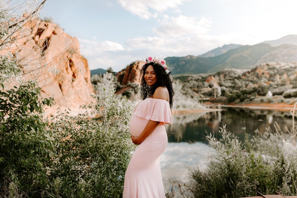 Colorado Springs maternity photography. Pregnant woman posing for maternity photos in Colorado Springs during golden hour. Boho maternity dress. 